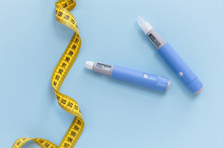 Two drugs injection ozempic for weight loss with a measuring yellow tape on a blue background.