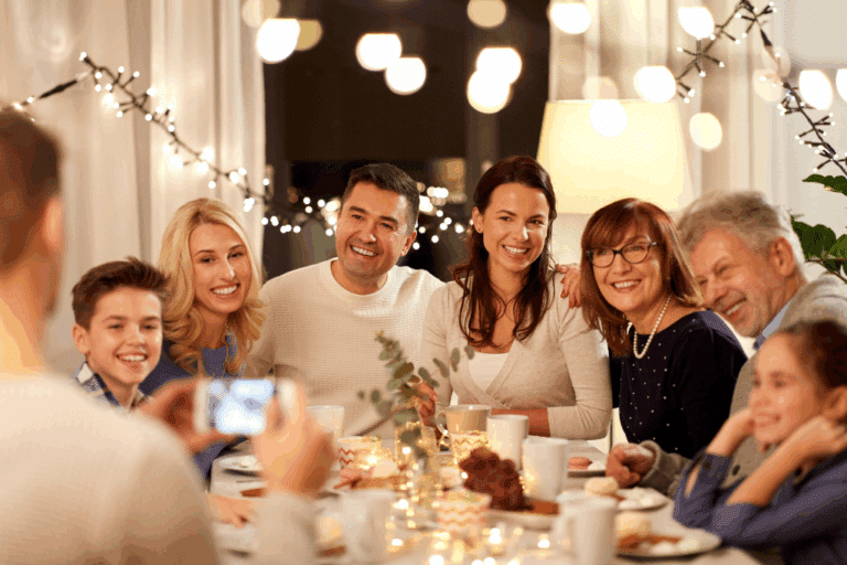 Multigenerational family enjoying stress-free holiday dinner together with warm lighting and festive decorations