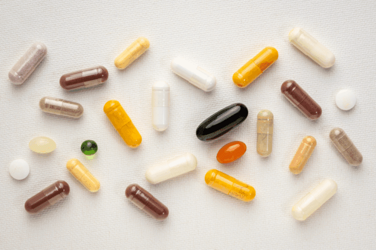 vitamins and supplements scattered on a white background