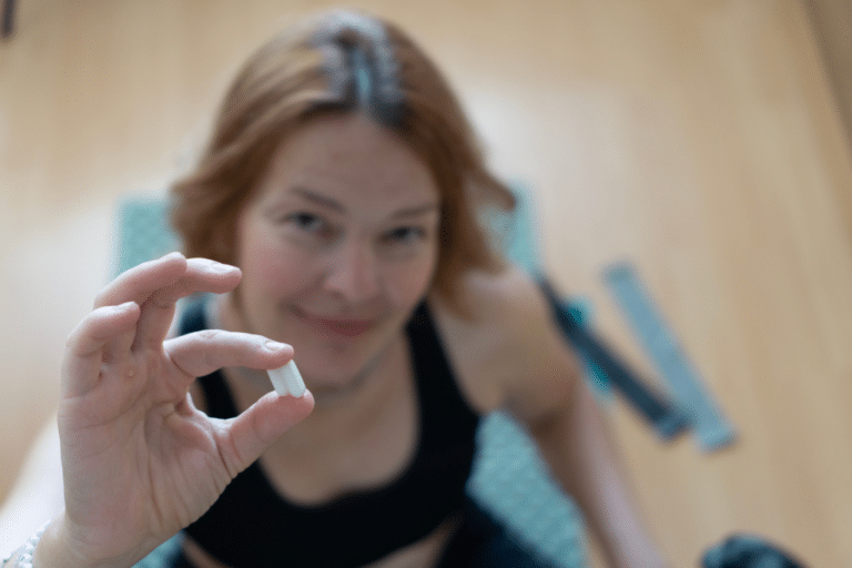 Midlife woman holding GLP-1 weight loss pill considering oral semaglutide medication for perimenopause weight management