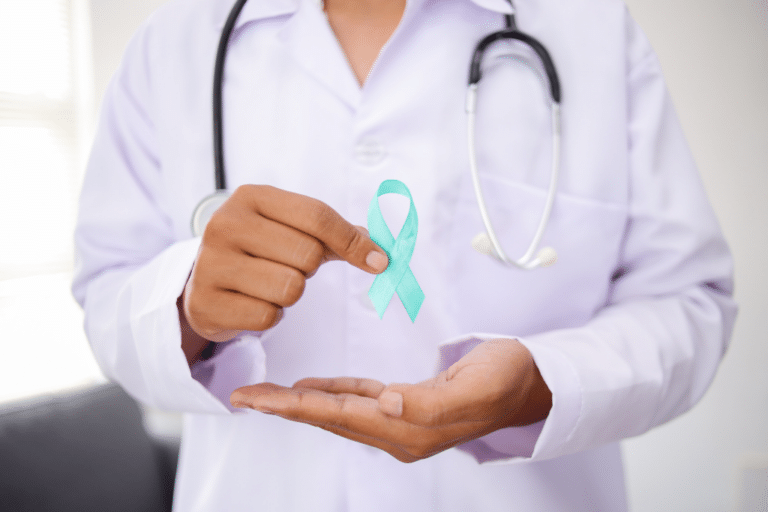 Doctor holding teal awareness ribbon representing PCOS PMOS polymetabolic ovarian syndrome diagnosis and women's hormonal health