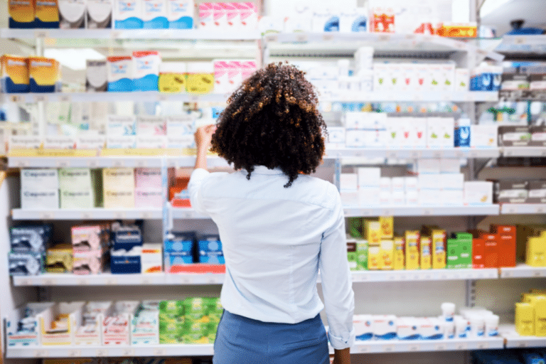 Woman reviewing progesterone and hormone therapy options on a pharmacy shelf